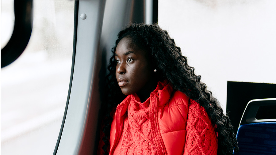 Person sits in a bus.