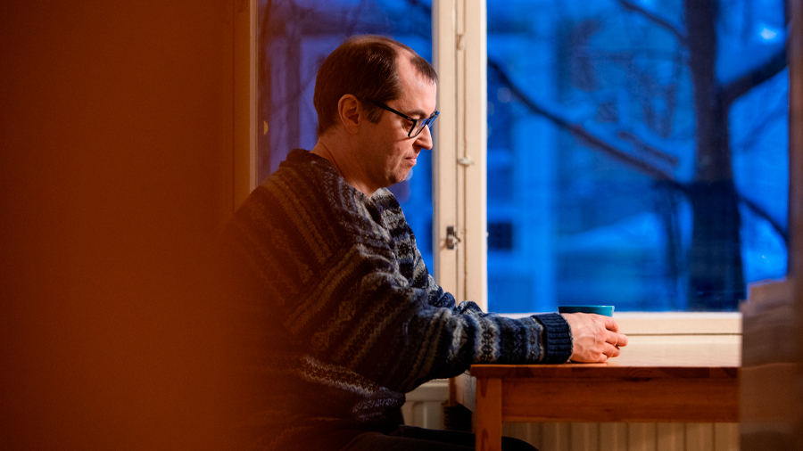 Man sitting by the table.